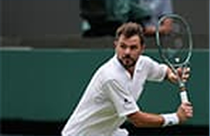 Stan Wawrinka celebrating with a clenched fist on a clay court