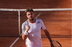 Stan Wawrinka at the net on a clay court